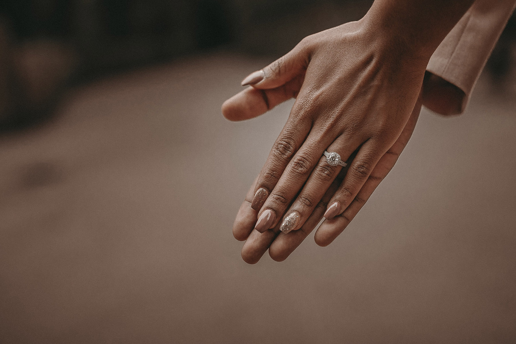 Couple showing off diamond engagement ring